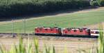 Eine Doppeltraktion Re 4/4 II der SBB zieht am 08.8.2020 einen Schnellzug bei Sissach BL Richtung Basel. Beim Personenwagen handelt es sich um einen mehrfach modernisierten Bpm. Diese Wagen waren ursprünglich für den internationalen Personenverkehr beschaft worden.