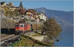 Die SBB Re 420 297-4 mit einen Güterzug auf der Fahrt Richtung Lausanne bei St-Saphorin.