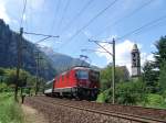 Re 4/4 11138 am 26.6.05 in Giornico. Im Hintergrund sieht man noch die Mittelalterliche Kirche San Michele und das Gotthard-Massiv (17.2.05) 
