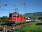 IR 2259 Re 4/4 11148 bei Schwyz, 31.07.2010.