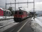 Re 4/4 II 11204 mit Leermaterialzug von Chur-Zrich in Maienfeld.