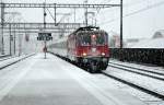 Die Re 4/4  11152 trifft am 18.12.12 mit einem IR am Haken und Schnee auf den Puffern in Lenzburg ein.