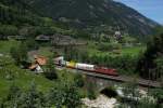 Re 4/4 II 11251 zeiht am 03.07.2014 einen Postzug die Gotthard-Nordrampe hinauf. Das Bild wurde in Wassen aufgenommen.