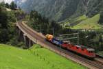 Eine Re 4/4 und eine BR 421 bringen einen sehr kurzen Güterzug in Richtung Andermatt.
Wassen, 20. August 2014.