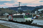 In der Dämmerung des Tages 5.1.2016 fährt das Gespann Re 456 016 und der Triebwagen RBDe 561 081 anlässlich einer Probefahrt zur Höfner Narrenfahrt bei Schwyzerbrugg vorüber.