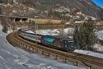 460 023-5 mit der Werbung Hauseigentümer HEV fährt mit einem IR bei Wassen vorüber.Bild vom 19.2.2015