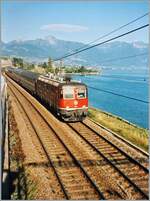 Die scheinbar erst vor kurzem rot gefärbte SBB Re 6/6 11636 Vernier Meyrin fährt mit dem EC  40  Monteverdi  von Venezia nach Genève kurz vor Rivaz am Genfersee entlang.