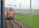 Mit vielen Holcim-Kieswagen passiert die Re 6/6 11604  Faido  die grnen Weiden nahe Oberrti und kreuzt dabei die S26 nach Othmarsingen.