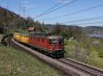 Die Re 6/6 11601 mit einem Postzug am 26.04.2012 unterwegs bei Immensee.