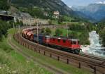 Eine Re 10/10 mit einem Gterzug am 28.08.2012 unterwegs bei Wassen.