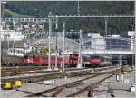 Ge 4/4 II 612  Thusis  mit RE nach Disentis, Ee 3/3 16428 und SBB Steuerwagen im westlichen Gleisvorfeld in Chur.