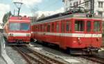 Triebwagen Neu BDe 4/4 614 + Bt + Triebwagen Alt BDe 4/4  607 + Bt im Bahnhofsareal von Saignelegier im Sept. 1990