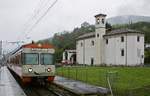 Auf dem Weg von Ponte Tresa nach Lugano trifft ein Be 4/12 der FLP am 08.05.2019 in Caslano ein, im Hintergrund die im 18.