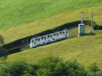 Pilatusbahn - Triebwagen Bhe 1/2  29 unterwegs auf Bergfahrt in Alpnachstad am 10.09.2012 .. Standort des Fotografen auf einem Schiff auf dem Vierwaldstttersee
