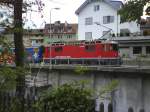 Die Ge 4/4 II stsst den Arosaexpress auf der Strasse in Chur an der Plesur entlang in Richtung Hbf Chur.