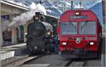 Dampfextrazug 2056 nach Landquart mit G 4/5 107  Albula  und RE1056 nach Landquart mit Steuerwagen 1754 in Davos Platz. (13.05.2018)