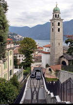 Wagen 1 und Wagen 2 der Trasporti Pubblici Luganesi SA (TPL), unterwegs als Standseilbahn Lugano–Bahnhof SBB (Funicolare Lugano Città–Stazione FFS) zwischen Lugano Stazione (CH) und Lugano Città (CH) begegnen sich an der Ausweiche bzw. Zwischenstation Lugano Cattedrale (Kathedrale San Lorenzo).
Selbige ist auch hier zum Teil abgebildet.
Aufgenommen von einer Fußgängerbrücke.
[20.9.2019 | 14:57 Uhr]