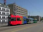 Dreiwagenzug mit dem Be 4/4 490  FC Basel Drmmli  an der Spitze berquert die Dreirosenbrcke Richtung Haltestelle Novartis Campus. Die Aufnahme stammt vom 28.04.2012.