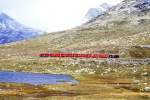 RhB Regionalzug 454 von Tirano nach St.Moritz am 28.08.1995 am Lago Nero zwischen Ospizio Bernina und Bernina Lagalb mit Triebwagen ABe 4/4 III 52 - B 2334 - B 2311 - B 2308 - B 2309 - Gb 5913. Hinweis: Lago Nero Wasserspiegel 2223m .NN, gescanntes Dia.
