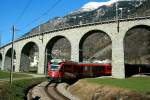 Der Bernina Express verlässt auf dem Weg nach Tirano das Kreisviadukt von Brusio; 23.02.2014