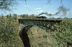 Dampfzug auf der Victoria Falls Bridge.
Aufnahme vom Juli 1997. Soweit ich mich erinnere, war dies ein Dampfzug, der zwischen Bulawayo und Victoria Falls fuhr. Hier ist der Zug auf die Brücke gefahren, um den Passagieren einen guten Ausblick zu gewähren.