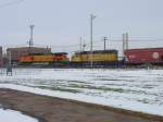 BNSF 5370 & Canadian Pacific 5424 round the curve from the freight yard onto Market Street in Burlington, Iowa.