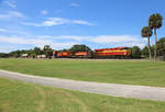 810 & 819 cross Daytona Golf Club whilst hauling FEC101-05 from Bowden to Hialeah, 5 July 2018