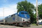 Amtrak #27, GE Genesis model P42DC. Wolverine service, train #352, with service from Chicago, Illinois to Pontiac, Michigan, arriving 25 minutes late in Kalamazoo, Michigan on 22.06.2006. The Genesis is pushing three passenger cars and an unpowered control/baggage unit over the Elm Street crossing.